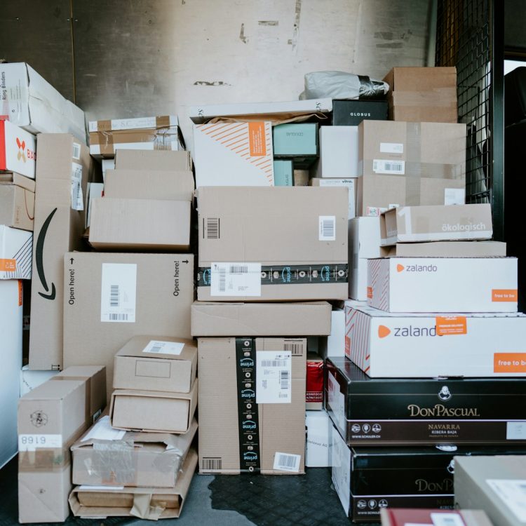 Photo by Claudio Schwarz brown cardboard boxes on black plastic crate